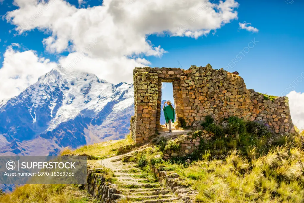 Woman enjoying the view high in the Andes Mountains while exploring Inti Punku (Sun Gate), Cusco, Peru, South America