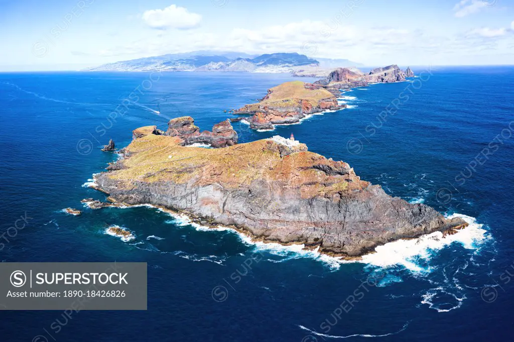 Aerial view of lighthouse on cliffs in the blue Atlantic Ocean, Sao Lourenco Peninsula, Canical, Madeira island, Portugal, Europe