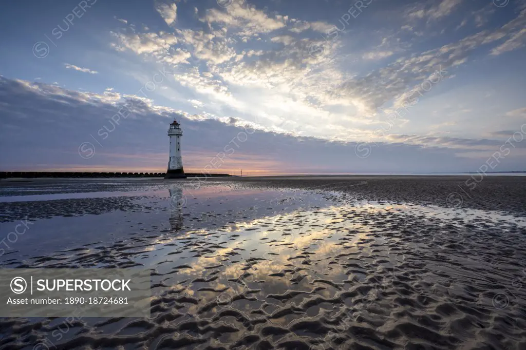 New Brighton Lighthouse reflected in sand at sunset, New Brighton, Cheshire, England, United Kingdom, Europe