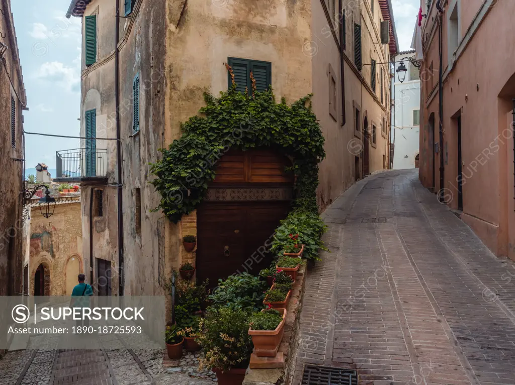 A person walking in the central streets of Trevi's old town at a fork, Trevi, Umbria, Italy, Europe