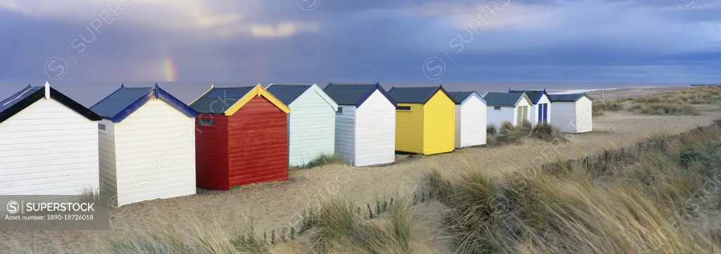 Beach huts and sand dunes with rainbow in evening light, Southwold, Suffolk, England, United Kingdom, Europe