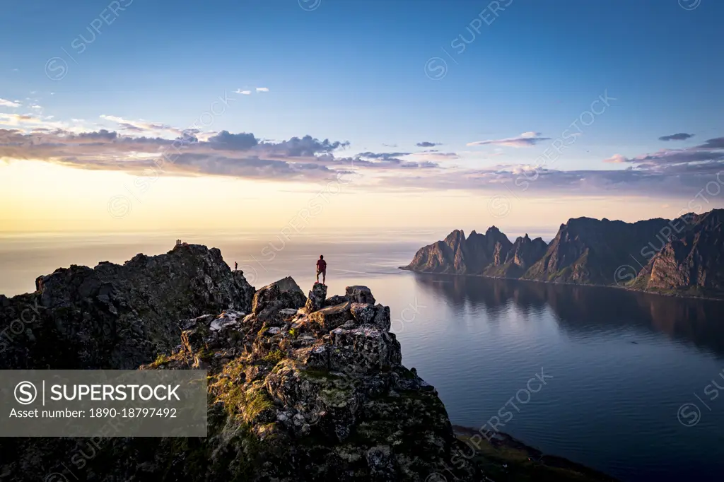 Person contemplating sunset from top of mountains, Senja island, Troms county, Norway, Scandinavia, Europe