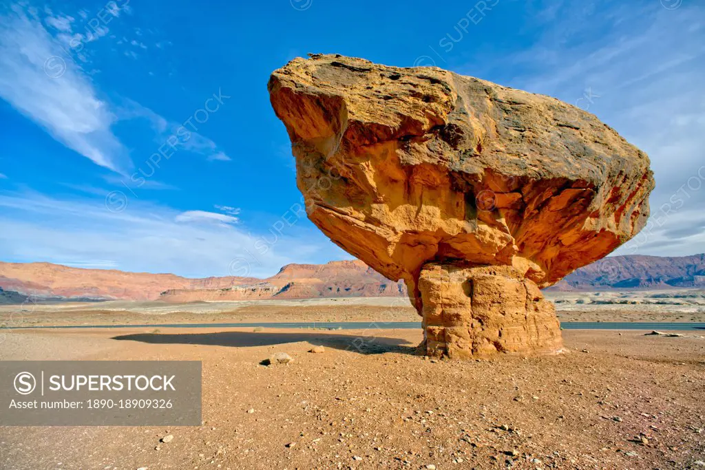 Balanced boulder at the base of Vermilion Cliffs in Glen Canyon Recreation Area, Arizona, United States of America, North America