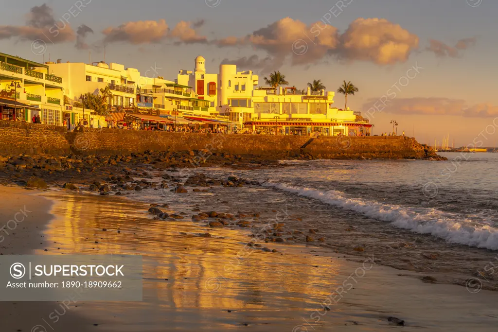 View of beach and cafes and bars during golden hour, Playa Blanca, Lanzarote, Canary Islands, Spain, Atlantic, Europe