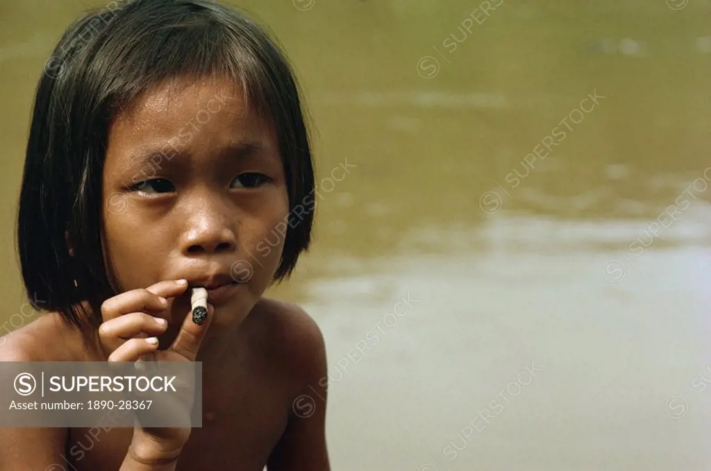 Kayan child smoking, along the Balui River, Sarawak, Malaysia, Southeast Asia, Asia