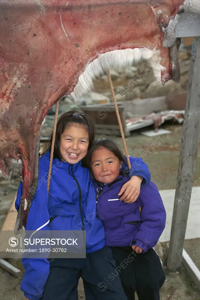 Inuit girls on swing with drying caribou skin, Chima, Pangnitung, Baffin Island, Canadian Arctic, Canada, North America