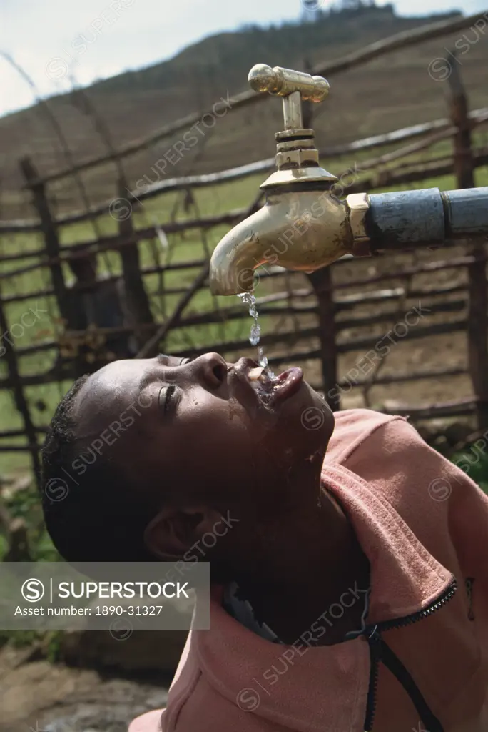 Wollo boy drinking from protected spring, Ethiopia, Africa