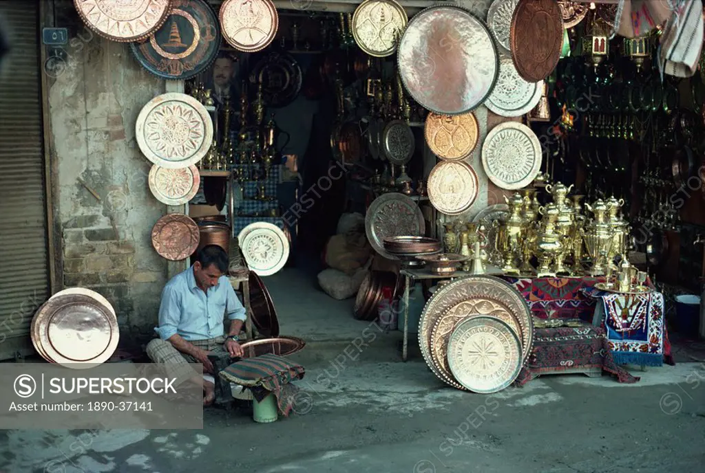 Man working on copper plate outside a copper souk, Baghdad, Iraq, Middle East