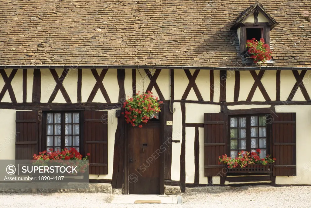 Typical timbered French cottage with geraniums in window boxes and hanging basket, Normandy, France, Europe