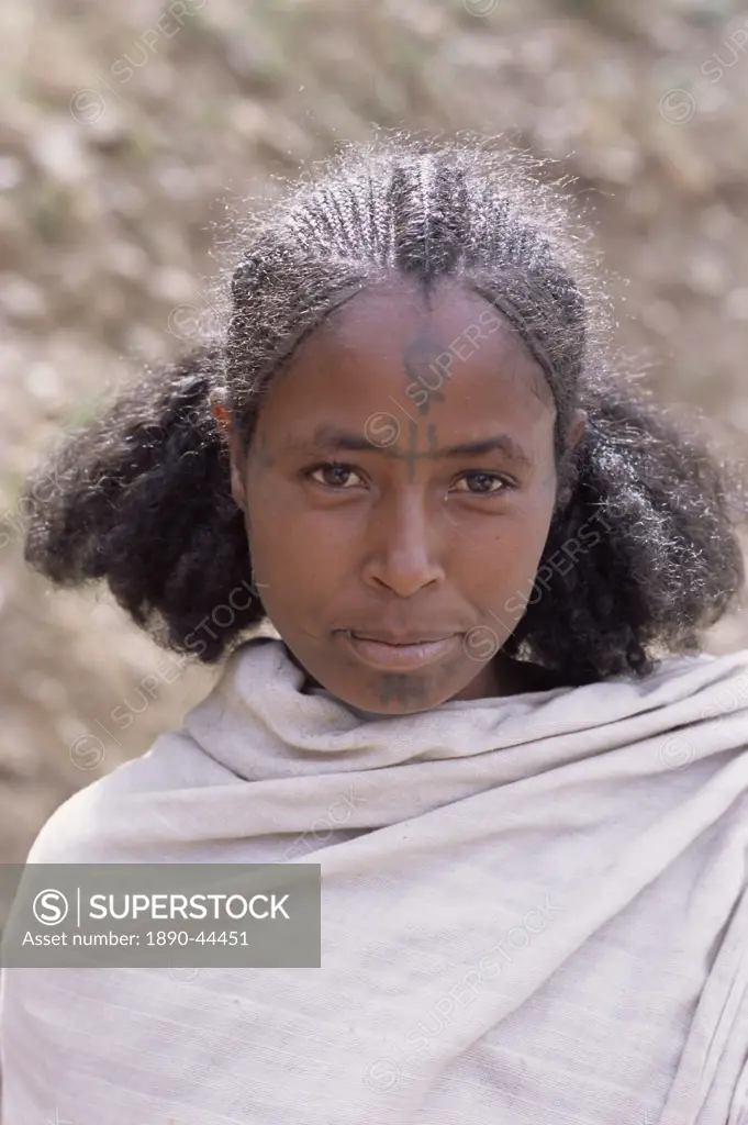 Head and shoulders portrait of a young Gourage woman with facial tattoo, Lasta Valley, Wollo region, Ethiopia, Africa