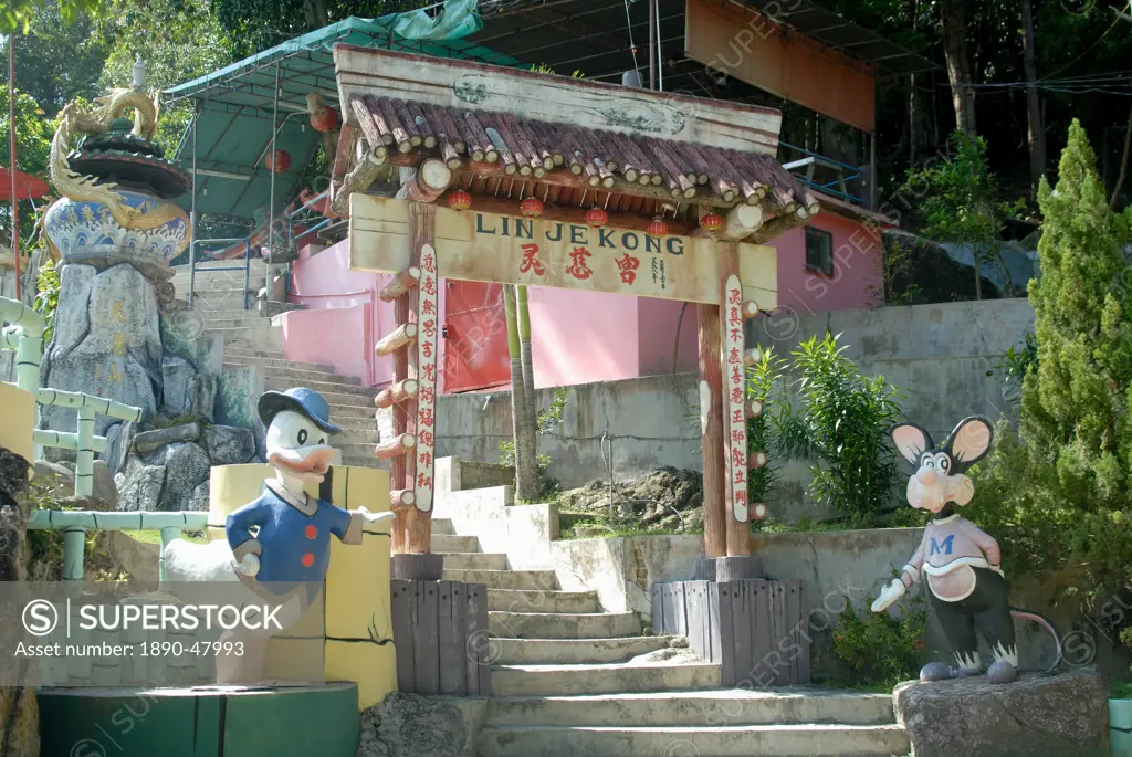 Donald Duck and Micky Mouse are unusual decorations with usual dragon at entrance to Chinese Temple, Coral Bay, Pangkor Island, Perak State, Malaysia,...