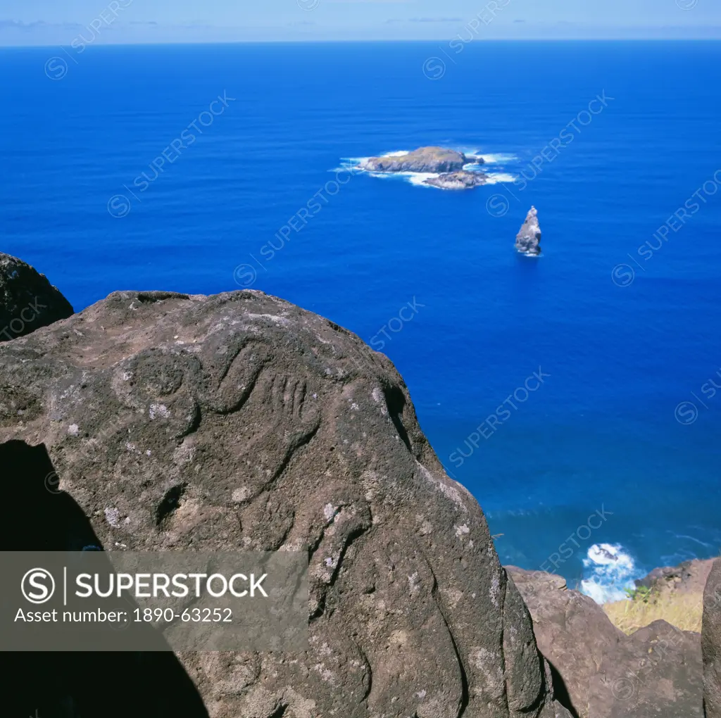 Birdman petroglyphs at Orongo ceremonial village on rim of crater Rano Kau, offshore lie bird islands of Motu Kao Kao, Motu Iri and Motu Nui, Easter I...