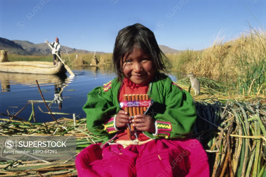 Portrait of a Uros Indian girl holding pan pipes, Islas Flotantes, Lake Titicaca, Peru, South America