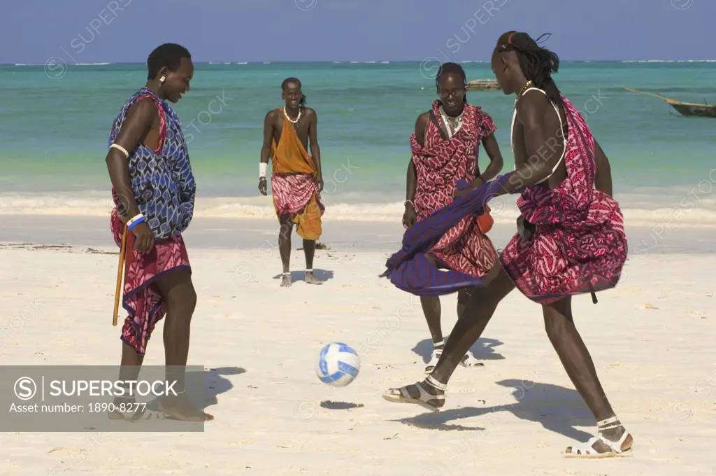 Maasai tribesmen in colourful native dress playing football on the beach, Paje, Zanzibar, Tanzania, East Africa, Africa