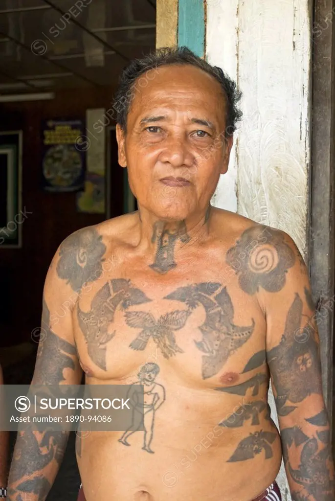 Jugah, an Iban tribal longhouse head man Tuai Rumah, with traditional warrior tattoos, Kapit district, Sarawak, Malaysian Borneo, Malaysia, Southeast ...