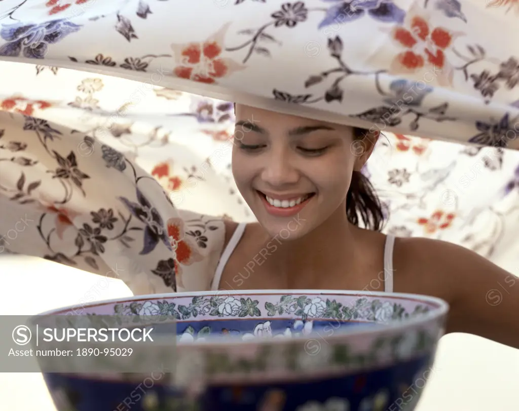 Aromatherapy, young woman prepares to inhale steam