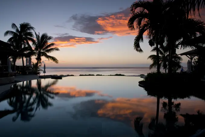 Sunset over an infinity pool at the Lux Le Morne Hotel on Le Morne Brabant Peninsula in south west Mauritius, Indian Ocean, Africa