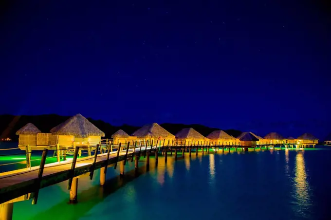 Overwater bungalows at night, Le Taha'a Resort, Tahiti, French Polynesia, South Pacific, Pacific