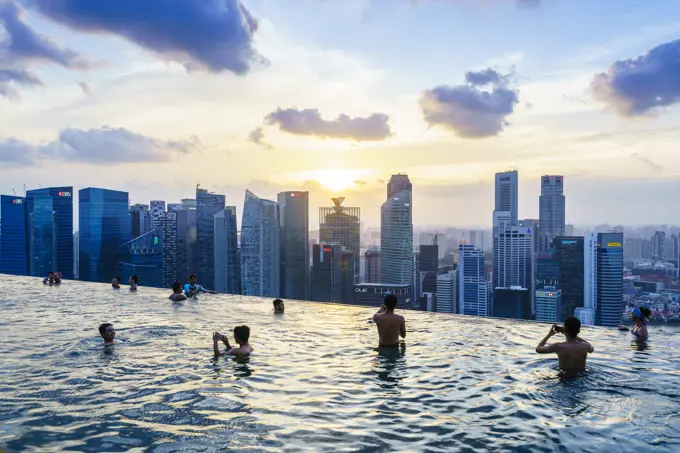 Infinity pool on the roof of the Marina Bay Sands Hotel with spectacular views over the Singapore skyline at sunset, Singapore, Southeast Asia, Asia