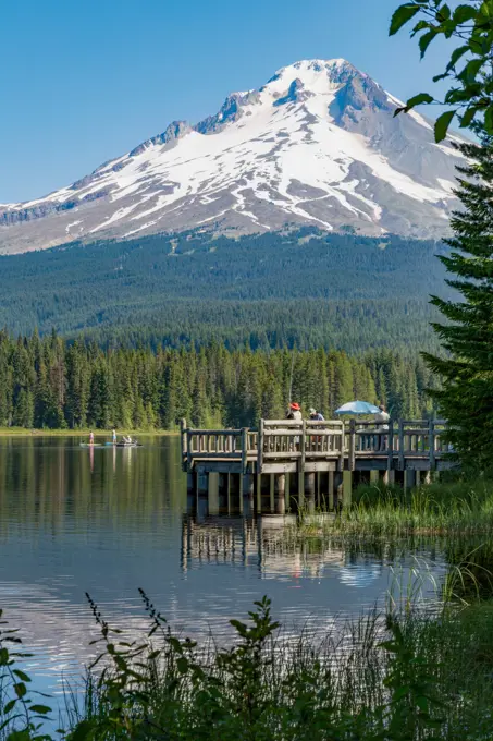 Fishing on Trillium Lake with Mount Hood, part of the Cascade Range, reflected in the still waters, Oregon, United States of America, North America