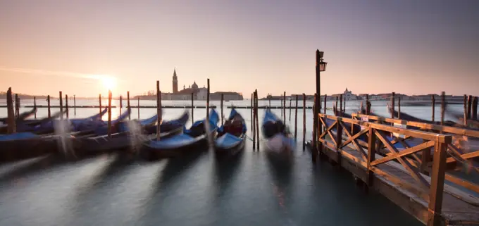 View towards San Giorgio Maggiore at dawn from Riva Degli Schiavoni, with gondolas in foreground, Venice, UNESCO World Heritage Site, Veneto, Italy, E...