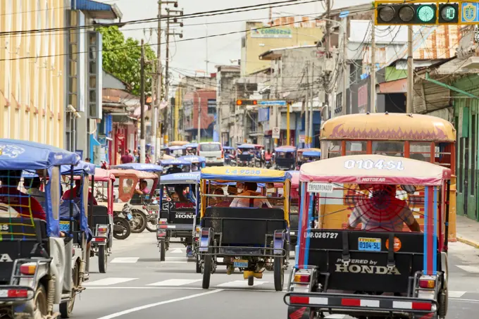 Mototaxis in a busy street in Iquitos, Peru, South America