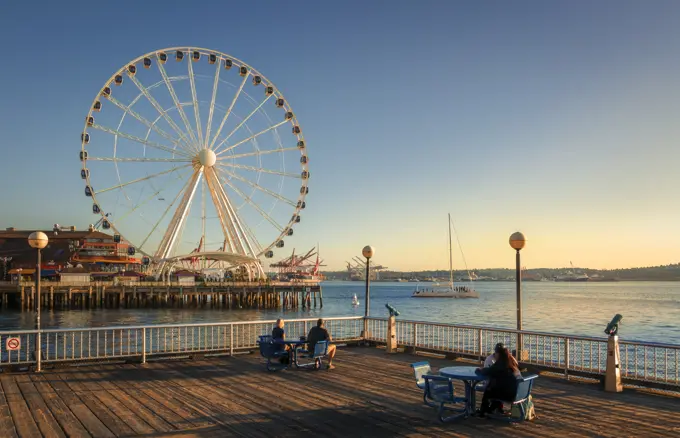 People enjoying the view of Seattle Great Wheel from Waterfront Park in Seattle, Washington State, United States of America, North America