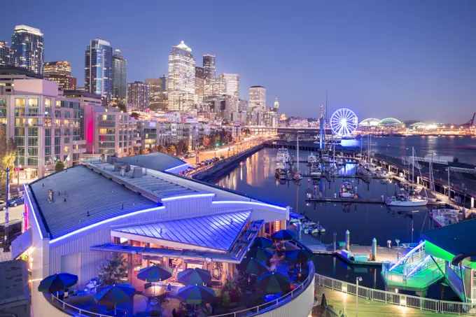 Elevated view of Seattle skyline and restaurants in Bell Harbour Marina at dusk, Belltown District, Seattle, Washington State, United States of Americ...