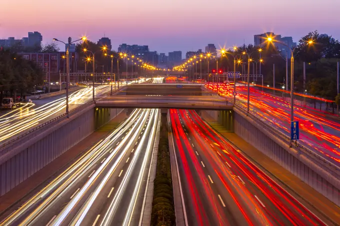 Traffic trail lights on major road near Beijing Zoo at dusk, Beijing, People's Republic of China, Asia