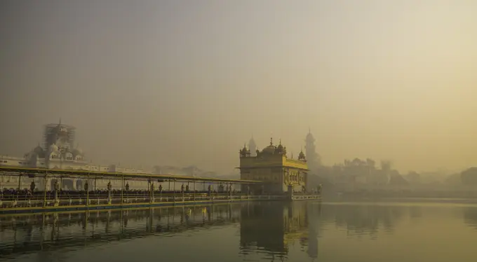 The Golden Temple at sunrise through fog, Amritsar, Punjab, India, Asia