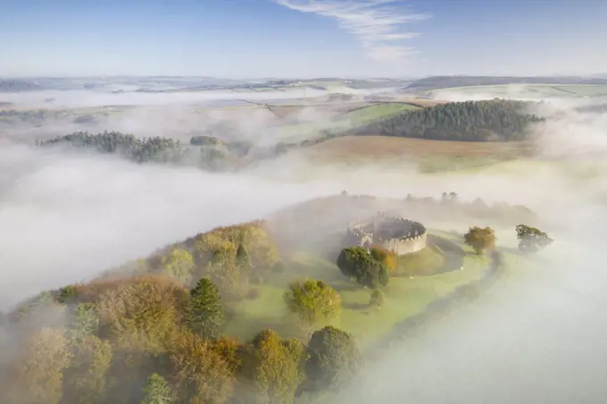 Aerial view by drone of Restormel Castle on a misty autumn morning, Lostwithiel, Cornwall, England, United Kingdom, Europe