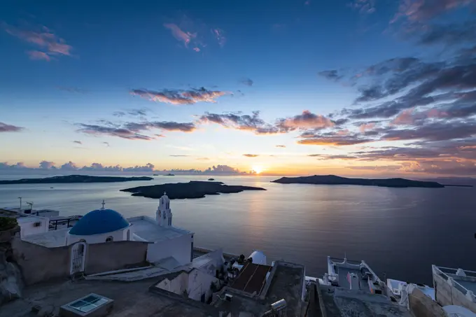 Sunset over the volcanic islands of Santorini and Anastasi Orthodox Church at sunset, Fira, Santorini, Cyclades, Greek Islands, Greece, Europe