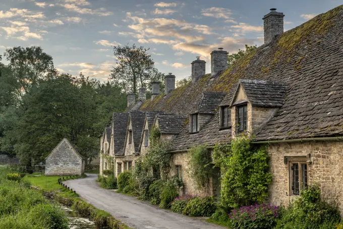 Early Spring morning view of the beautiful Cotswolds cottages at Arlington Row in Bibury, Gloucestershire, England, United Kingdom, Europe