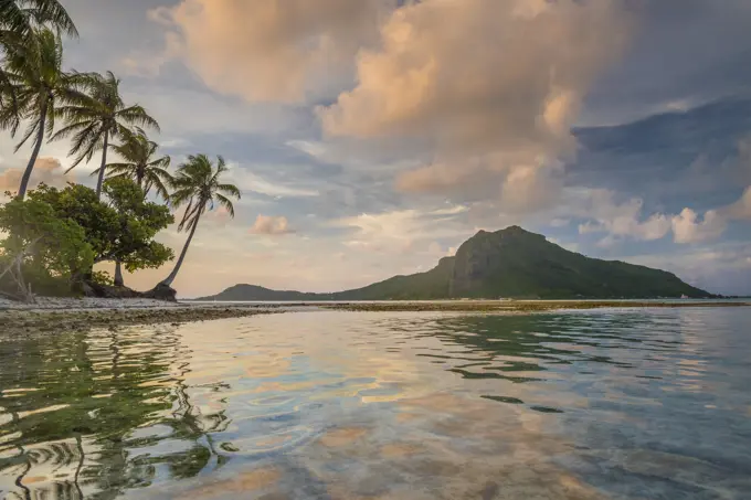 A calm evening in the lagoon of Bora Bora as a cloud forms on top of the mountain, Bora Bora, Tahiti, Society Islands, French Polynesia, Pacific