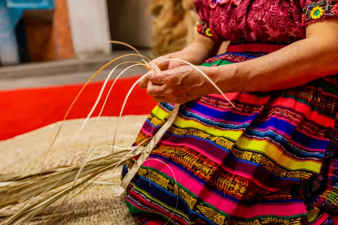 K'iche artisans weaving straw hats, Guatemala, Central America