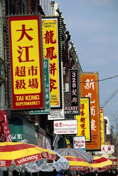 Bi_lingual Chinese and English signs on Spadina Avenue in Chinatown in downtown Toronto, Ontario, Canada, North America