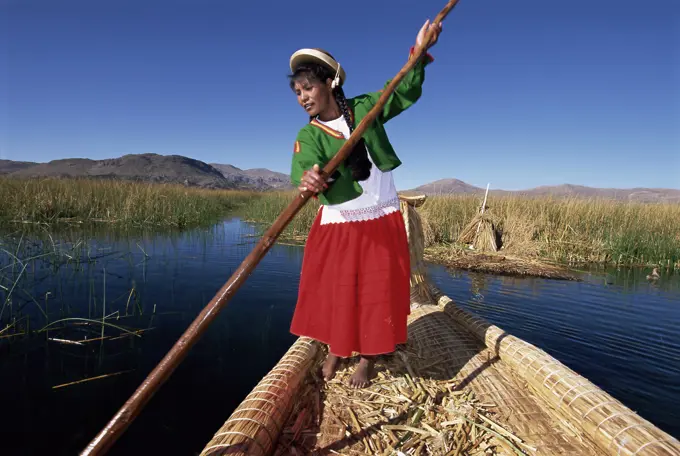 Portrait of a Uros Indian woman on a traditional reed boat, Islas Flotantes, floating islands, Lake Titicaca, Peru, South America