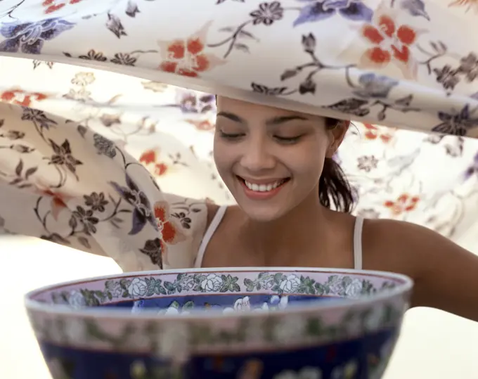 Aromatherapy, young woman prepares to inhale steam