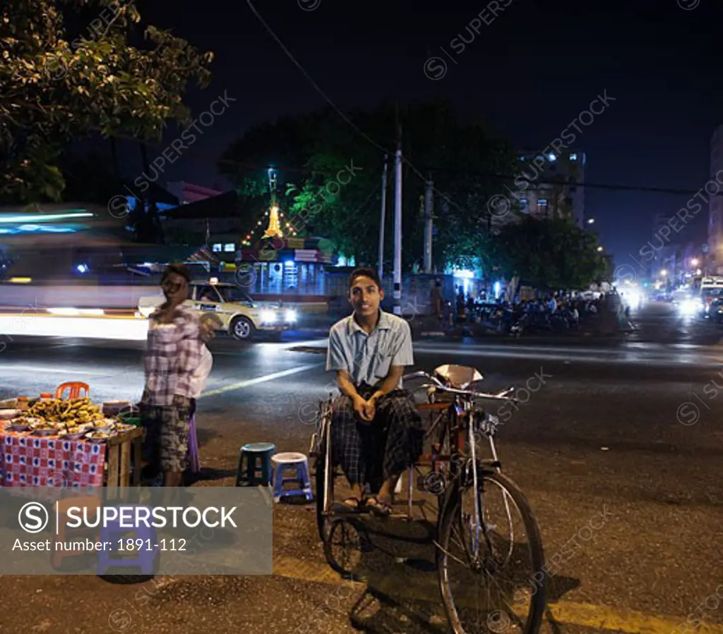 Man sitting on a pedicab, Yangon, Myanmar