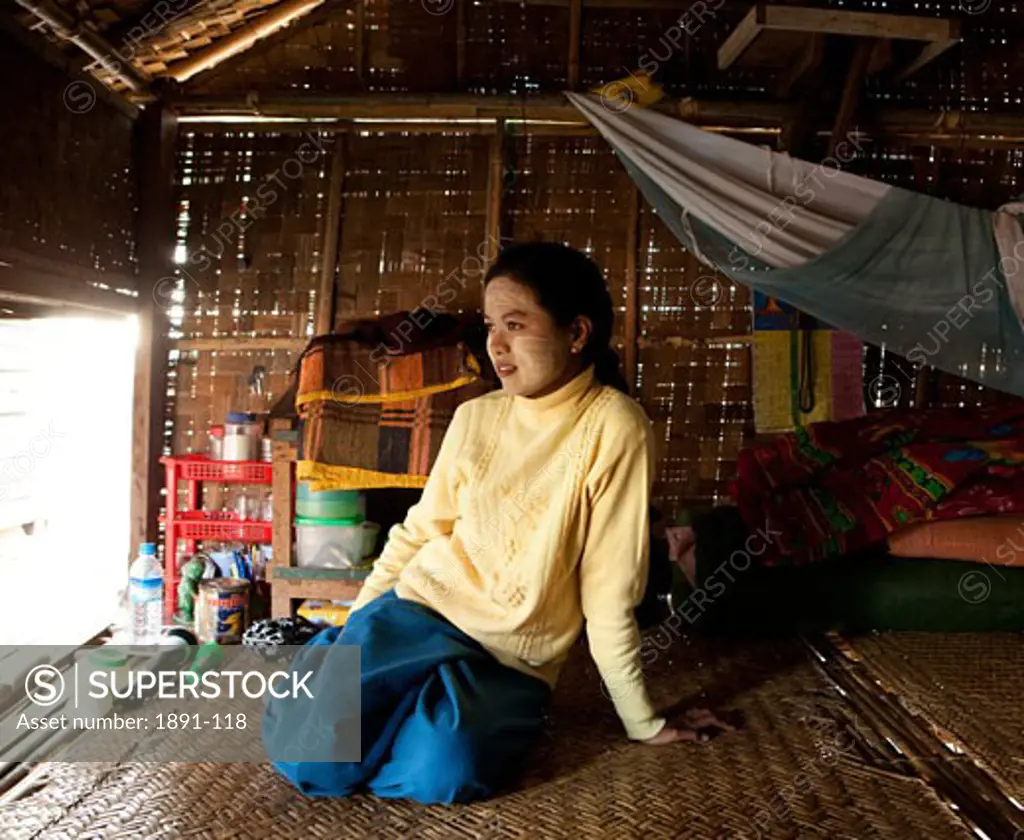 Woman sitting in a house, Myanmar