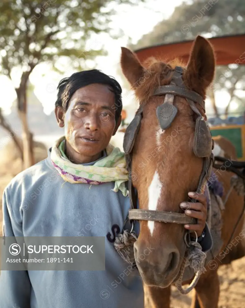 Man standing with a horse, Myanmar