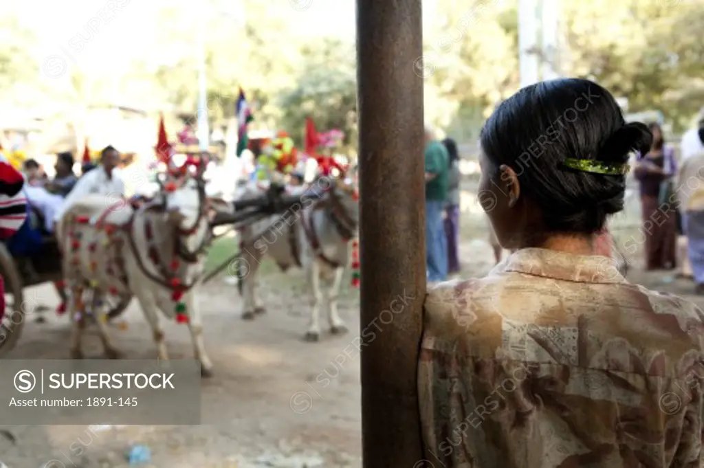 Woman watching a traditional ceremony, Myanmar