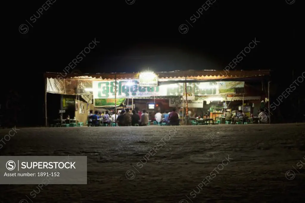 Tea shop lit up at night, Myanmar