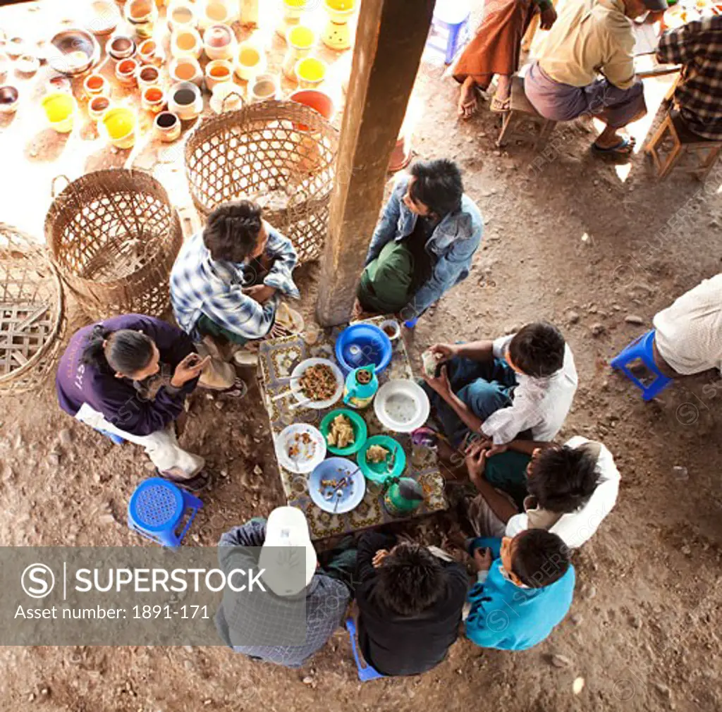 Group of people having lunch at a market, Myanmar