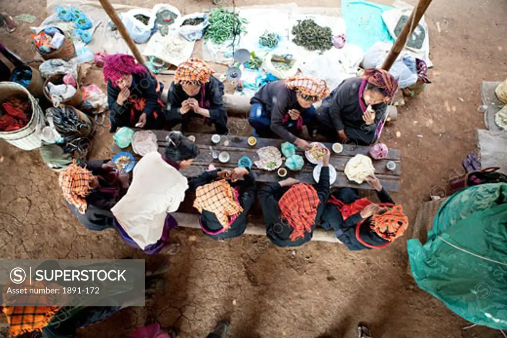 Group of people having lunch at a market, Myanmar