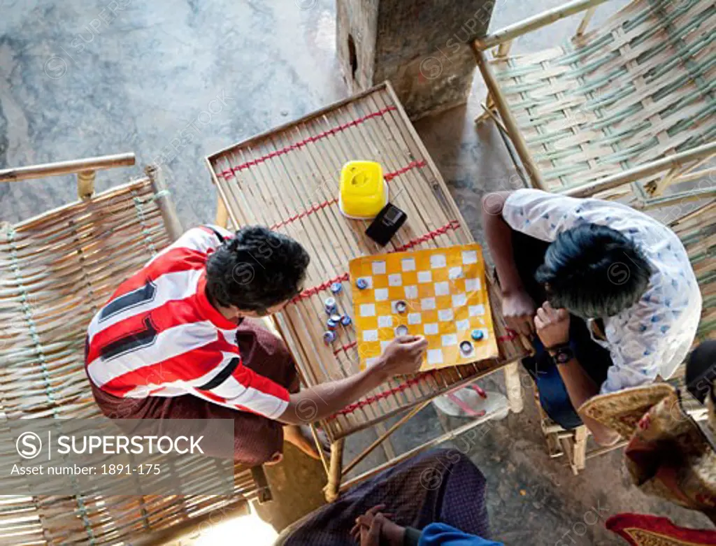 Teenage boys playing chess, Myanmar