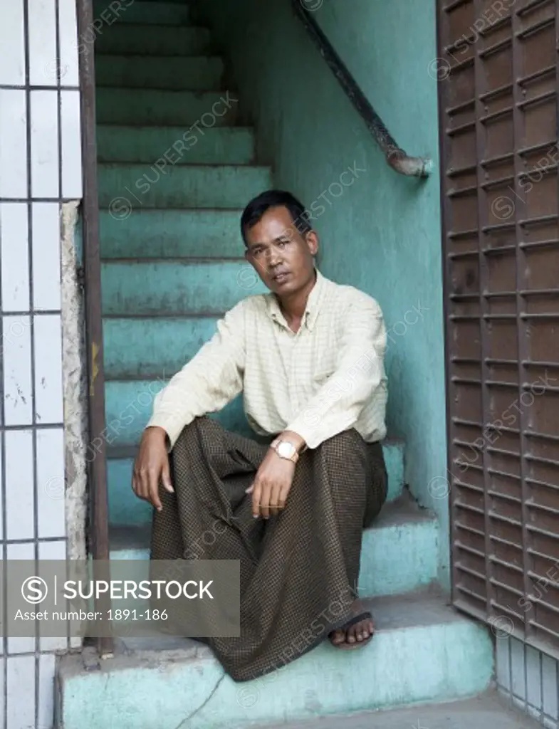 Man sitting on steps, Myanmar