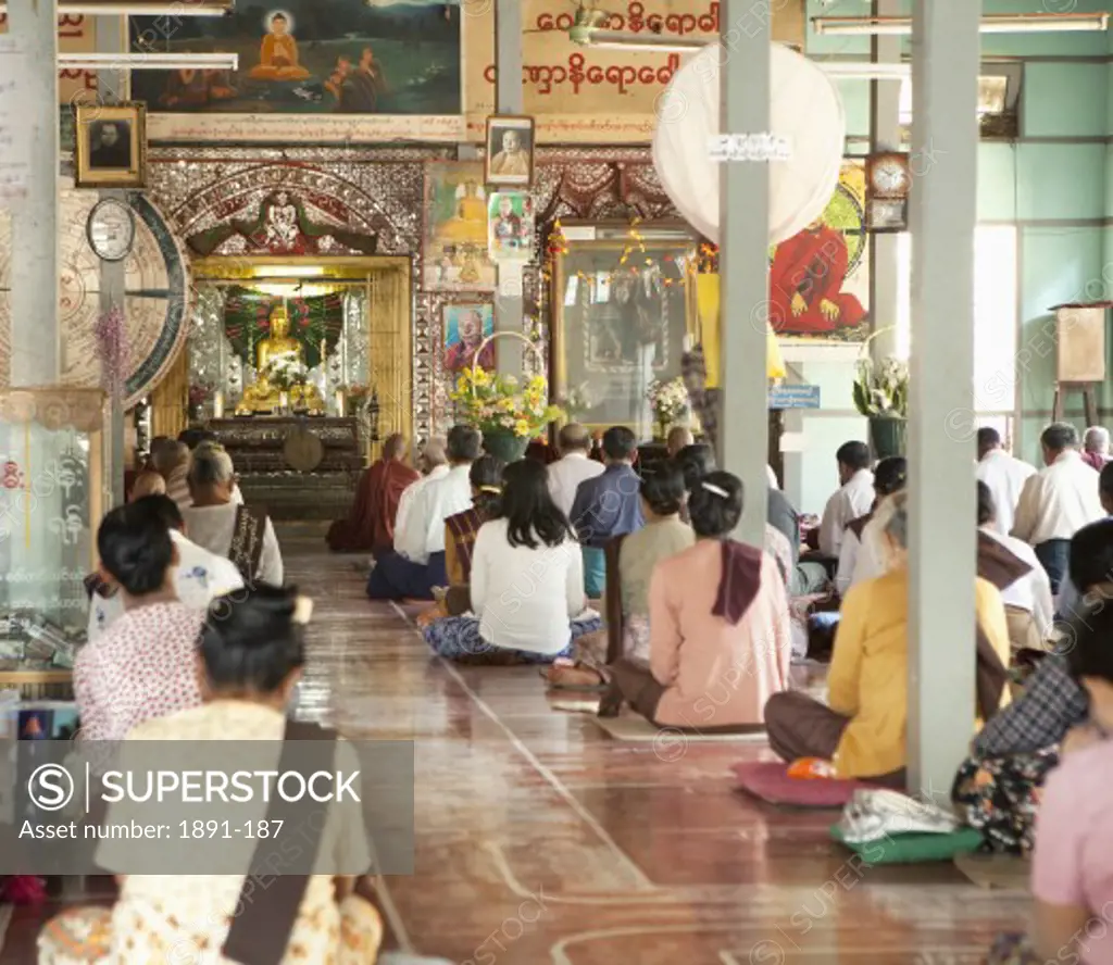 Group of people praying to Buddha, Myanmar