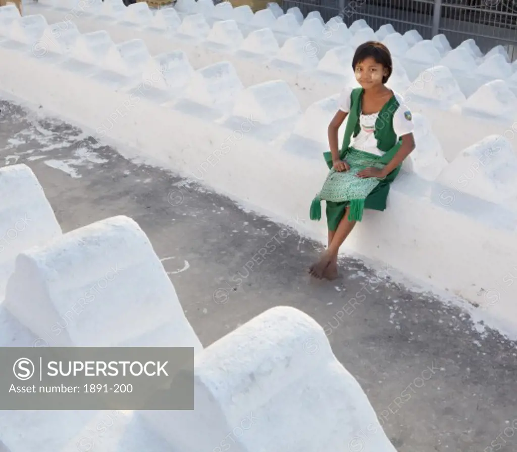 Girl sitting at a temple, Mandalay, Myanmar