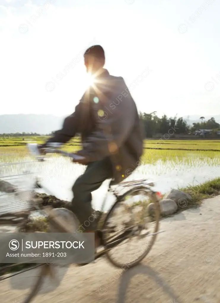 Myanmar, Man riding bicycle